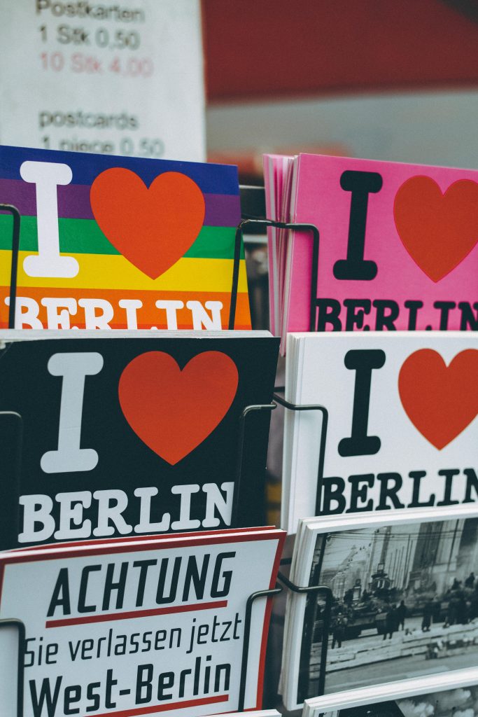 Vibrant postcards featuring 'I Love Berlin' designs in a Berlin shop display.